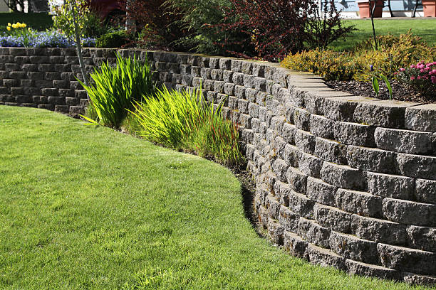 beautiful gray Retaining wall alongside lush green grass.