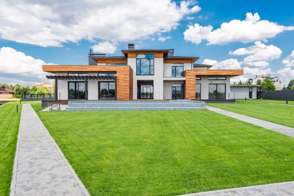 luxury modern house with green lawn and blue sky