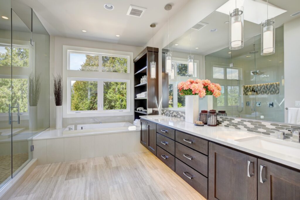 a large bathroom with a walk in shower and double sinks